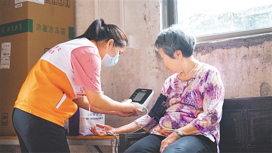 這是一雙不辭辛勞的手。江門市中心醫(yī)院蓬江分院環(huán)市街道社區(qū)衛(wèi)生服務(wù)中心護(hù)士劉娟冒雨上門，為基層群眾測量血壓、送藥，開展常規(guī)檢查和日常健康指導(dǎo)，將關(guān)懷與專業(yè)送進(jìn)千家萬戶。