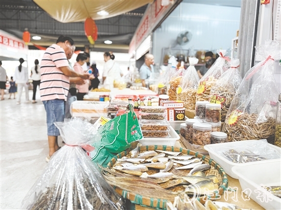 游客紛紛到海鮮特產(chǎn)市場挑選海味。